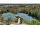 Aerial shot showcasing two tennis courts within a community, surrounded by trees and landscaping for a private feel at 13149 Steinhatchee Loop, Venice, FL 34293