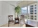 Balcony with seating, a tall plant, and views of the building and city skyline beyond the railings at 1350 Main St # 1701, Sarasota, FL 34236