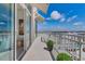 A condo balcony with white metal railings offers views of blue sky and high rise buildings in the distance at 1350 Main St # 1701, Sarasota, FL 34236