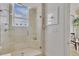 Bathroom featuring a glass shower, a rain shower head, a window, and a view from the shower at 1350 Main St # 1701, Sarasota, FL 34236