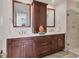 Bathroom featuring a double vanity with a rich wood cabinet, white countertop, and a glass enclosed shower at 1350 Main St # 1701, Sarasota, FL 34236