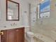 Bathroom featuring a vanity with dark wood cabinets, a white countertop, and a glass-enclosed shower at 1350 Main St # 1701, Sarasota, FL 34236