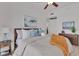 Bright bedroom features cozy decor, including a plush bed, nautical accents, and colorful artwork at 1350 Main St # 1701, Sarasota, FL 34236