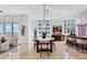 Open-concept dining area featuring a large table, city views, and modern lighting at 1350 Main St # 1701, Sarasota, FL 34236