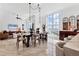 Open-concept dining room featuring floor to ceiling windows and modern light fixtures at 1350 Main St # 1701, Sarasota, FL 34236