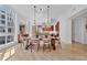A dining room with a large wood table set for six, with a view of the modern kitchen at 1350 Main St # 1701, Sarasota, FL 34236
