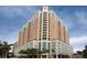 High-rise building with multiple balconies, detailed architecture, blue skies and palm trees at 1350 Main St # 1701, Sarasota, FL 34236