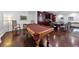 An elegant game room features a full-size pool table and a wet bar with seating and custom cabinetry at 1350 Main St # 1701, Sarasota, FL 34236