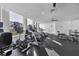 Bright gym space features several cardio machines, black flooring, and a large window providing natural light and a view at 1350 Main St # 1701, Sarasota, FL 34236