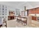 Open kitchen with modern appliances, marble countertops, barstool seating, and stylish lighting fixtures at 1350 Main St # 1701, Sarasota, FL 34236