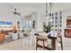 Open-concept living space with dining table and comfortable seating area with large windows overlooking the city at 1350 Main St # 1701, Sarasota, FL 34236