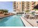 Beautiful pool with lounge chairs at building with balconies, a perfect relaxation spot at 1350 Main St # 1701, Sarasota, FL 34236