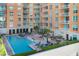 Aerial view of a stylish pool surrounded by lounge chairs and lush landscaping at condo building at 1350 Main St # 1701, Sarasota, FL 34236