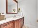 Powder room features a dark wood vanity with a white countertop and a decorative plant at 1350 Main St # 1701, Sarasota, FL 34236