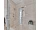 Elegant walk-in shower with glass enclosure, multiple shower heads, and built-in shelving at 1350 Main St # 1701, Sarasota, FL 34236