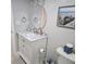 Bathroom featuring marble countertop vanity with oval mirror and framed beach scene wall art at 1350 N Portofino Dr # 108, Sarasota, FL 34242