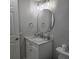 Well-lit bathroom with marble countertop vanity, modern fixtures, and round mirror at 1350 N Portofino Dr # 108, Sarasota, FL 34242