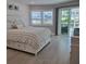 Comfortable bedroom with a queen-sized bed and sliding glass doors to the outdoor patio at 1350 N Portofino Dr # 108, Sarasota, FL 34242