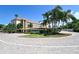 Well-maintained building exterior with lush landscaping and ample parking, enhancing curb appeal at 1350 N Portofino Dr # 108, Sarasota, FL 34242
