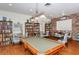 Well-lit game room featuring a pool table, bookshelves, and tables at 1350 N Portofino Dr # 108, Sarasota, FL 34242
