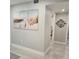 Light and airy hallway with beach-themed artwork and doorway to a bedroom at 1350 N Portofino Dr # 108, Sarasota, FL 34242
