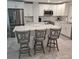 Bright kitchen boasts white cabinetry, stainless appliances, quartz counters, and a breakfast bar at 1350 N Portofino Dr # 108, Sarasota, FL 34242