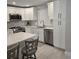 A beautifully renovated kitchen with white cabinets, stainless appliances, and an island with seating at 1350 N Portofino Dr # 108, Sarasota, FL 34242