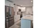 Bright and modern kitchen featuring white cabinets, stainless steel appliances, and a center island at 1350 N Portofino Dr # 108, Sarasota, FL 34242