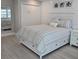 Inviting main bedroom featuring a comfortable bed with storage drawers and coastal-inspired decor at 1350 N Portofino Dr # 108, Sarasota, FL 34242