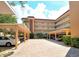 Exterior view of a charming multi-story condo building with covered parking and lush landscaping at 1350 N Portofino Dr # 108, Sarasota, FL 34242