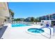 Community pool area with a large pool and hot tub at 1350 N Portofino Dr # 108, Sarasota, FL 34242