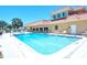 Community features a large pool with ample patio space and lush landscaping at 1350 N Portofino Dr # 108, Sarasota, FL 34242