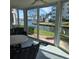 Enclosed sunroom with waterfront views, comfortable seating, and sliding glass doors at 1350 N Portofino Dr # 108, Sarasota, FL 34242