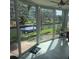 Bright sunroom with sliding glass doors offering views of the canal and a boat dock at 1350 N Portofino Dr # 108, Sarasota, FL 34242