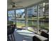 Bright sunroom featuring wicker furniture and panoramic views of the waterfront at 1350 N Portofino Dr # 108, Sarasota, FL 34242