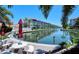 Scenic waterfront condo building with lush landscaping, boat docks and a lovely canal at 1350 N Portofino Dr # 108, Sarasota, FL 34242