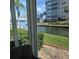 Stunning waterfront view from the property's sunroom, highlighting the building and greenery at 1350 N Portofino Dr # 108, Sarasota, FL 34242