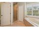 Bright bathroom with a soaking tub, walk-in shower and shuttered windows at 1655 Pinyon Pine Dr, Sarasota, FL 34240