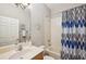 Bathroom with large mirror, blue shower curtain and vanity at 1655 Pinyon Pine Dr, Sarasota, FL 34240