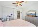 A comfortable bedroom featuring neutral walls and a desk with view into another room at 1655 Pinyon Pine Dr, Sarasota, FL 34240