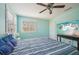 Aqua bedroom featuring a ceiling fan and large window at 1655 Pinyon Pine Dr, Sarasota, FL 34240
