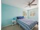 Bedroom featuring an aqua color scheme, ceiling fan, and shuttered windows at 1655 Pinyon Pine Dr, Sarasota, FL 34240