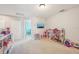 Spacious bonus room perfect for a playroom with shelving and TV at 1655 Pinyon Pine Dr, Sarasota, FL 34240