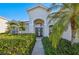 Inviting home exterior featuring tropical landscaping, a grand entryway, and a well-maintained lawn at 1655 Pinyon Pine Dr, Sarasota, FL 34240