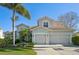 Well-maintained home featuring a spacious two-car garage and neutral exterior, complemented by beautiful landscaping at 1655 Pinyon Pine Dr, Sarasota, FL 34240