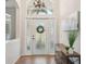 Bright and airy foyer features tile flooring, high ceilings, and stylish light fixtures at 1655 Pinyon Pine Dr, Sarasota, FL 34240