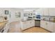 Lovely kitchen with white cabinetry, stainless steel dishwasher, granite countertops, and breakfast bar seating at 1655 Pinyon Pine Dr, Sarasota, FL 34240
