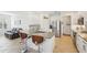 Bright kitchen with white cabinets, granite countertops, stainless steel appliances and breakfast bar seating at 1655 Pinyon Pine Dr, Sarasota, FL 34240