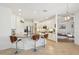 Modern kitchen boasts white cabinetry, stainless appliances, granite counters, and breakfast bar, open to living area at 1655 Pinyon Pine Dr, Sarasota, FL 34240