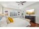 Comfortable main bedroom with hardwood floors, tray ceiling, and large windows providing ample natural light at 1655 Pinyon Pine Dr, Sarasota, FL 34240